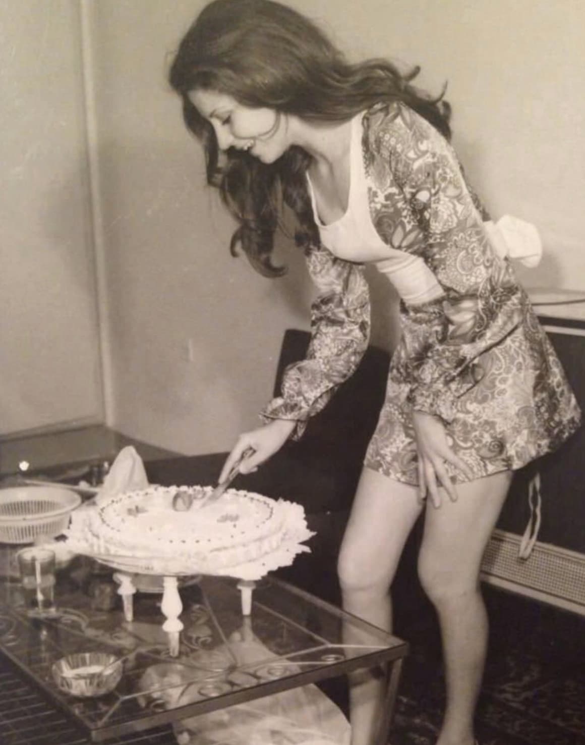 woman cutting birthday cake in iran